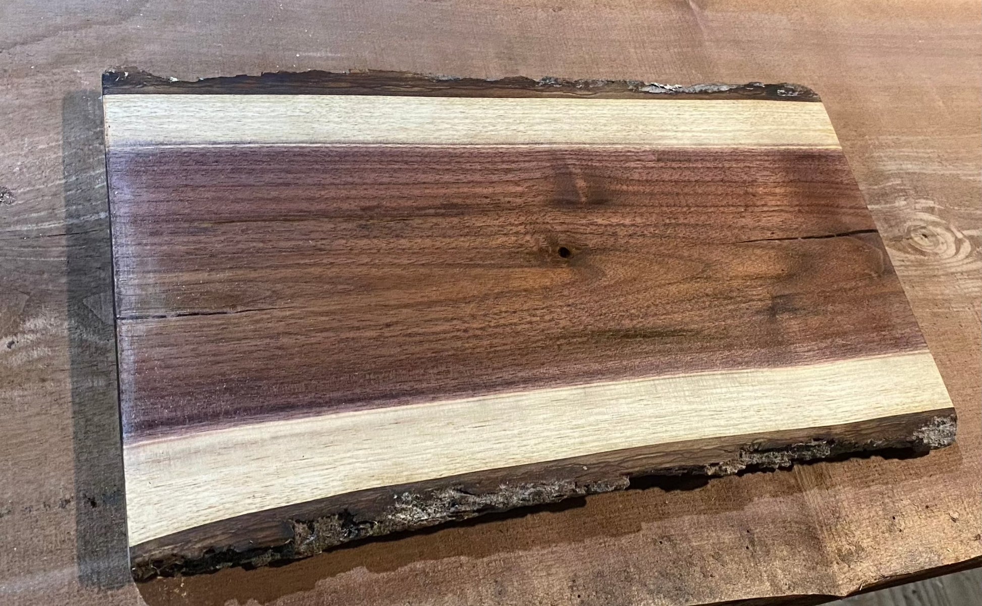 Our live edge black walnut cutting board is 12x8 inches, food safe and finished with beeswax and mineral oil.
