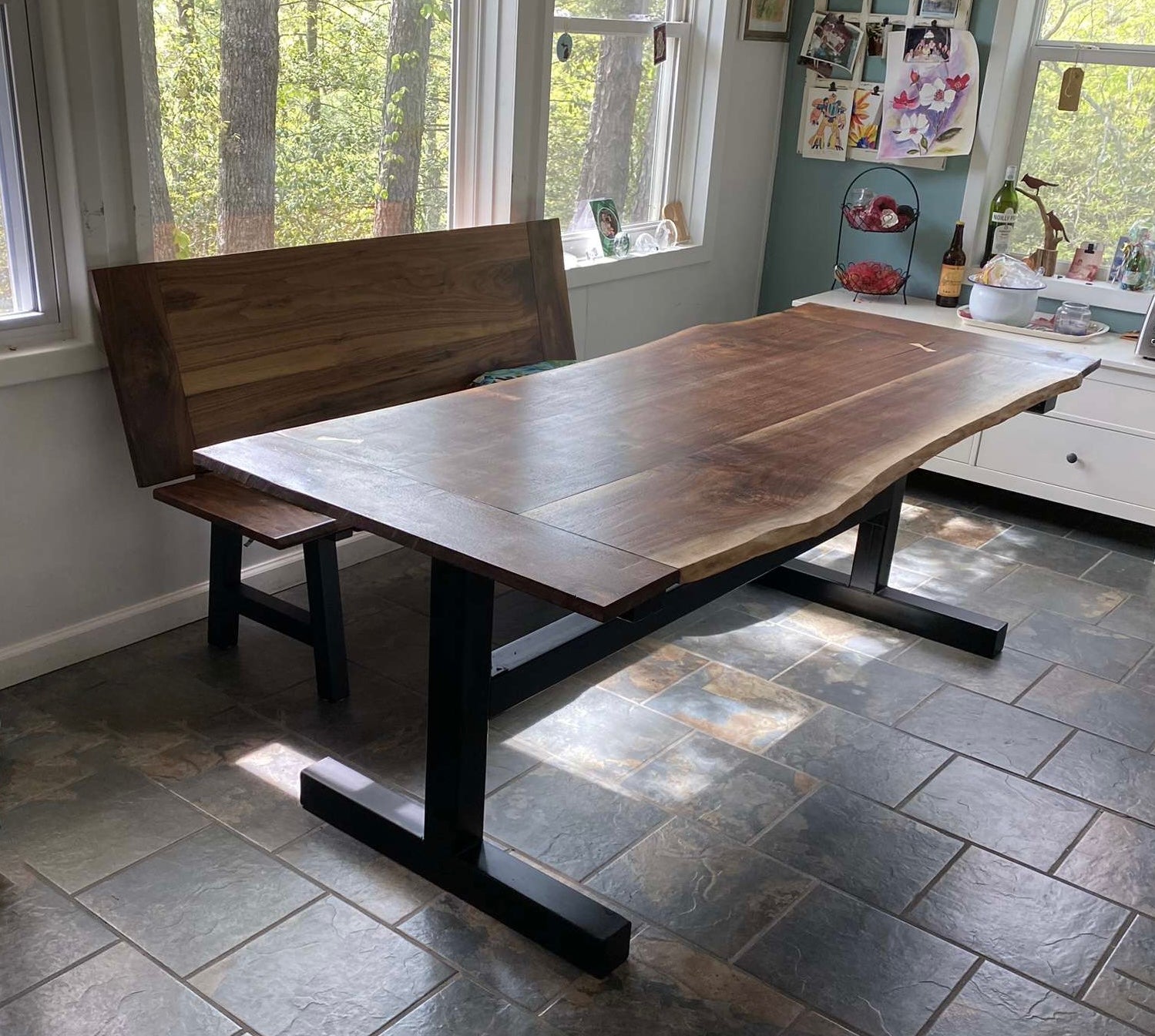Live edge dining table and bench made of black walnut and custom metal legs.